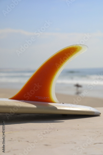 Photography Vertical shot of the detail of a surfing board at the beach