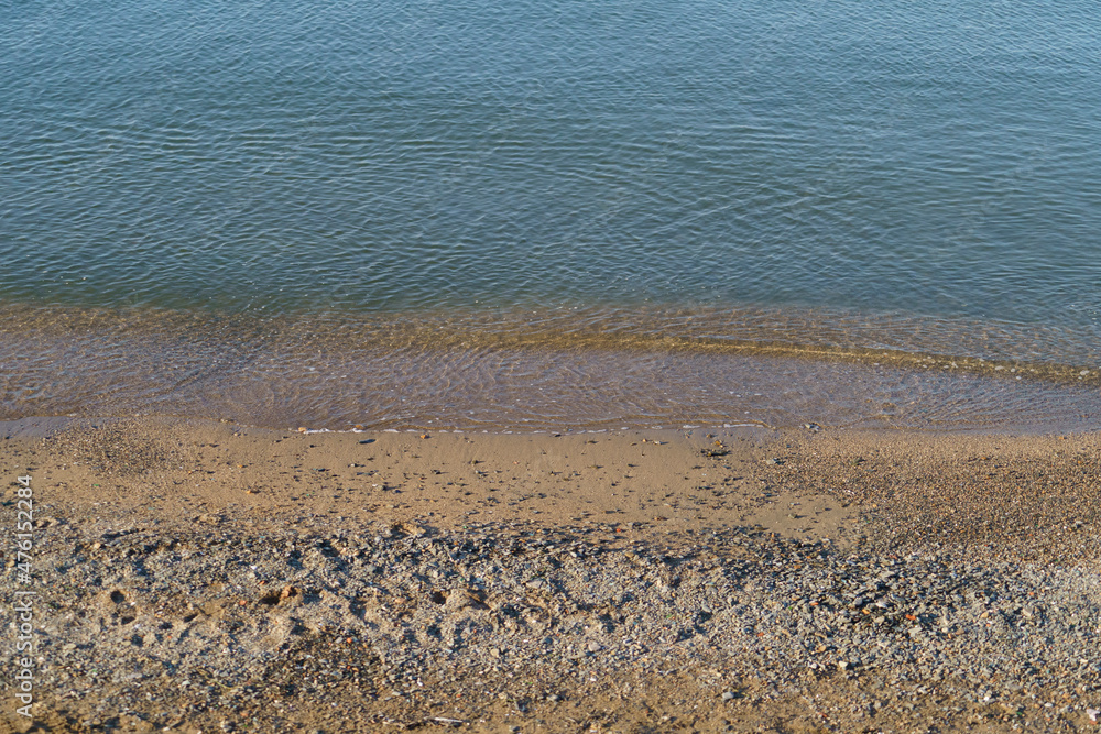 Natural background with a sea wave on a sandy beach Natural background with a sea wave on a sandy beach