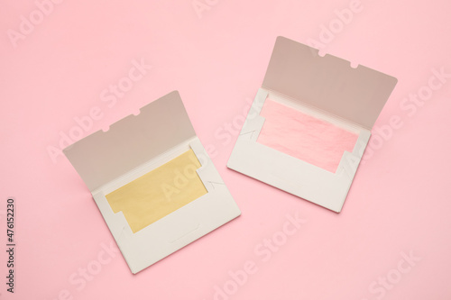 Facial oil blotting tissues on pink background, flat lay. Mattifying wipes