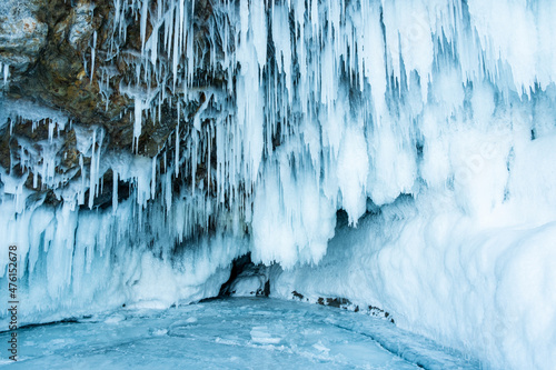 Huge icicles in an ice cave on the Lake Baikal in winter. Siberia, Russia.