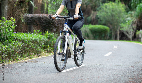 Riding a bike on tropical park trail