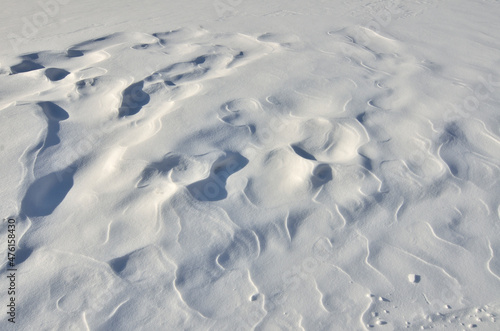 Wind created patterns on surface of  snow - abstract winter snowy background