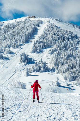  snowboarder is jumping with snowboard from snowhill. Skier skiing downhill in high mountains. Flying skier on mountains, winter extreme sport. 