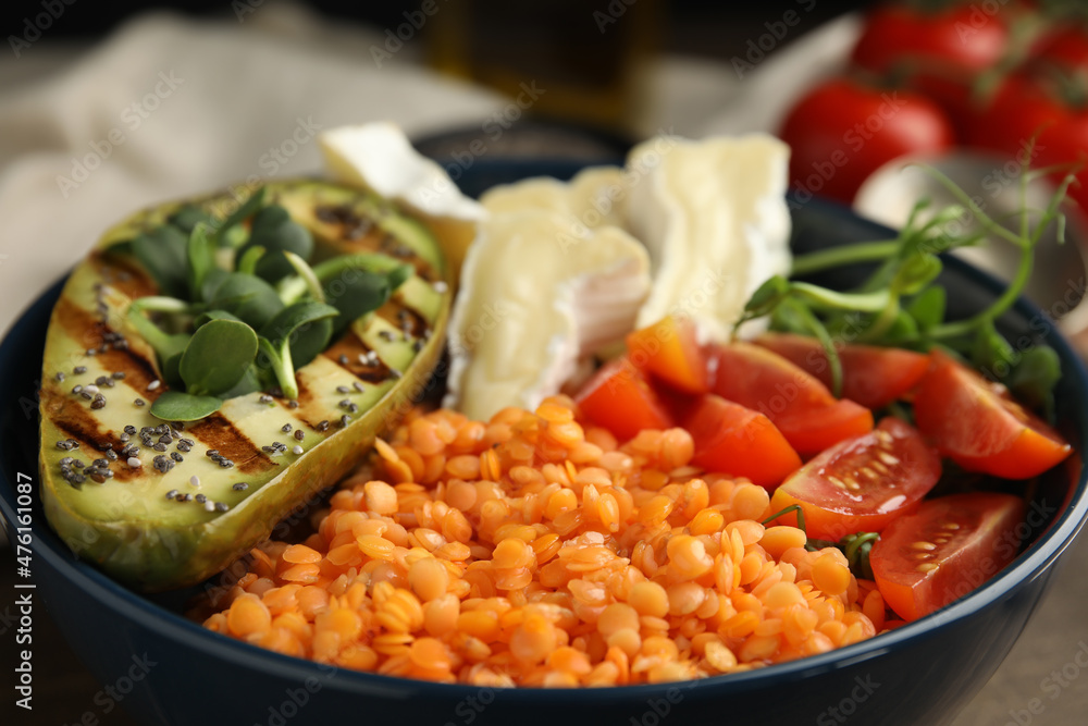 Delicious lentil bowl with soft cheese, avocado and tomatoes, closeup Delicious lentil bowl with soft cheese, avocado and tomatoes, closeup