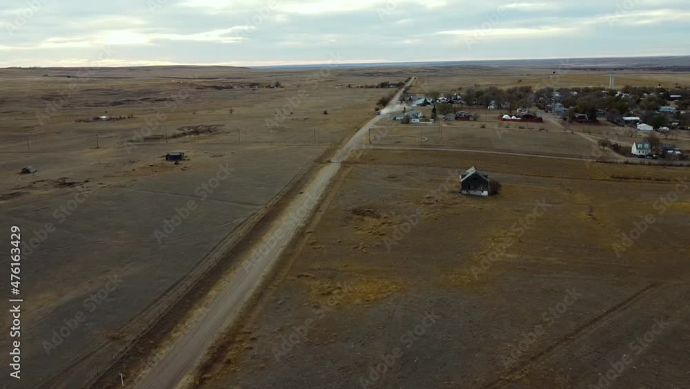 A dirt road in the country that leads into a small village Called Empress Alberta Canada. Filmed during the day with a drone. A dirt road in the country that leads into a small village Called Empress Alberta Canada. Filmed during the day with a drone.