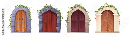 Antique medieval wooden door with handle, arch and ivy plant. Entrance, gate in a castle, church or house.