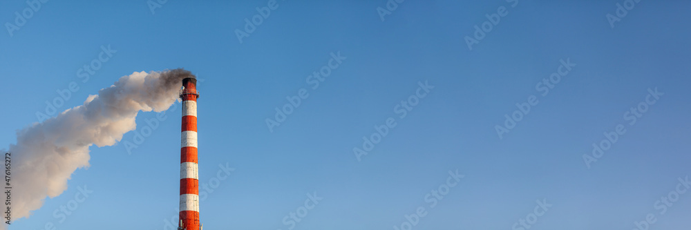 Banner. White thick smoke from the boiler room chimney. Smoke against the blue sky. Air pollution. Heating of the city. Industrial zone.