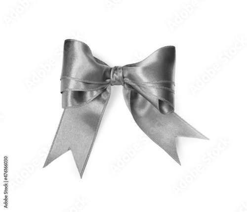 Silver satin ribbon tied in bow on white background, top view