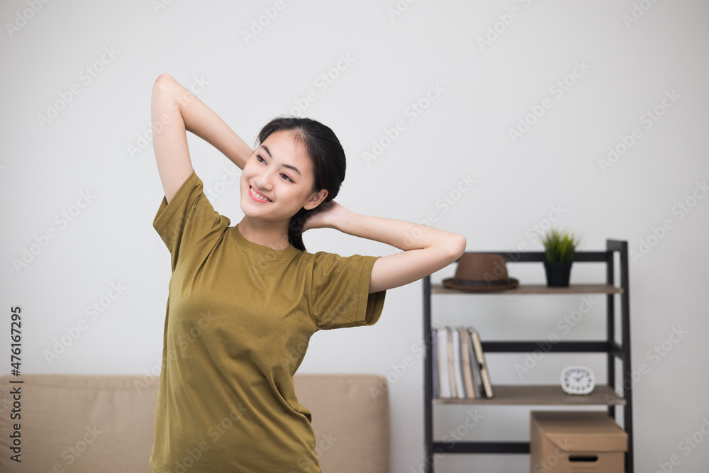 Attractive asian young fitness woman stretching arms warming up before workout at home. Beautiful smiling Female wearing sportswear exercise training yoga in living room. Attractive asian young fitness woman stretching arms warming up before workout at home. Beautiful smiling Female wearing sportswear exercise training yoga in living room.
