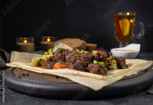grilled beef with vegetables on wooden board