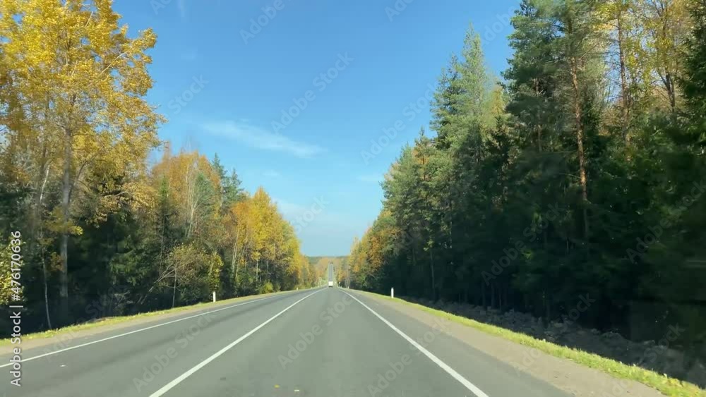 driving in a car on an autumn forest road driving in a car on an autumn forest road