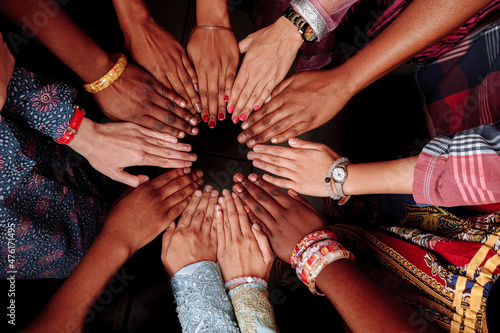 Hands of a group of multinational people which stay together in circle.