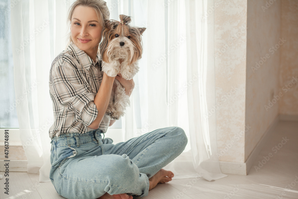 pretty blond woman have fun with little dog at home pretty blond woman have fun with little dog at home