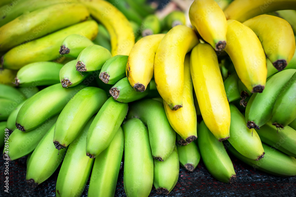 Bunch of large bananas on display at fruit stall in market Bunch of large bananas on display at fruit stall in market