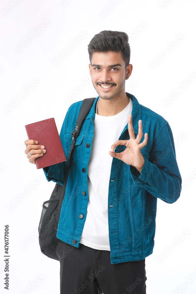 Indian college boy showing diary on white background. Indian college boy showing diary on white background.