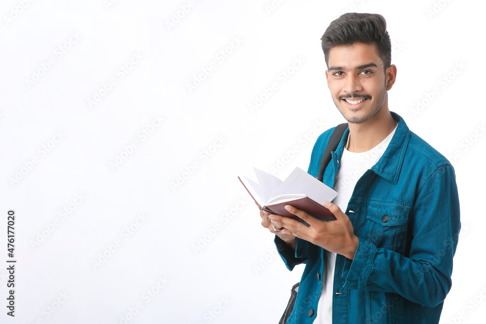 Young Indian college student holding dairy in hand on white background. Young Indian college student holding dairy in hand on white background.