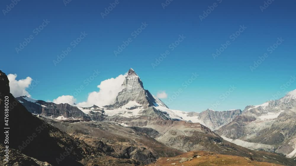 Timelapse of clouds moving against the Matterhorn mountain with clear blue sky in Switzerland in 4k. Timelapse of clouds moving against the Matterhorn mountain with clear blue sky in Switzerland in 4k.