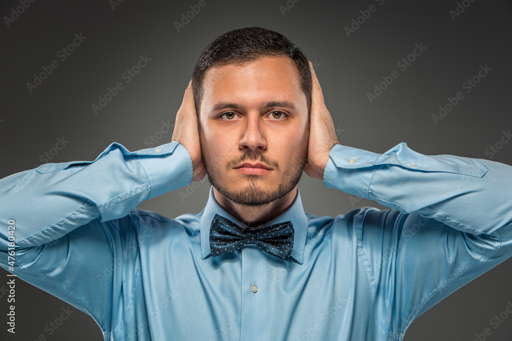 Portrait young man in blue shirt, looking at the camera Portrait young man in blue shirt, looking at the camera