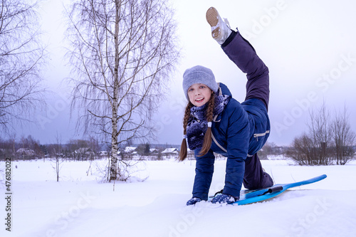 Beautiful girl rides downhill in winter