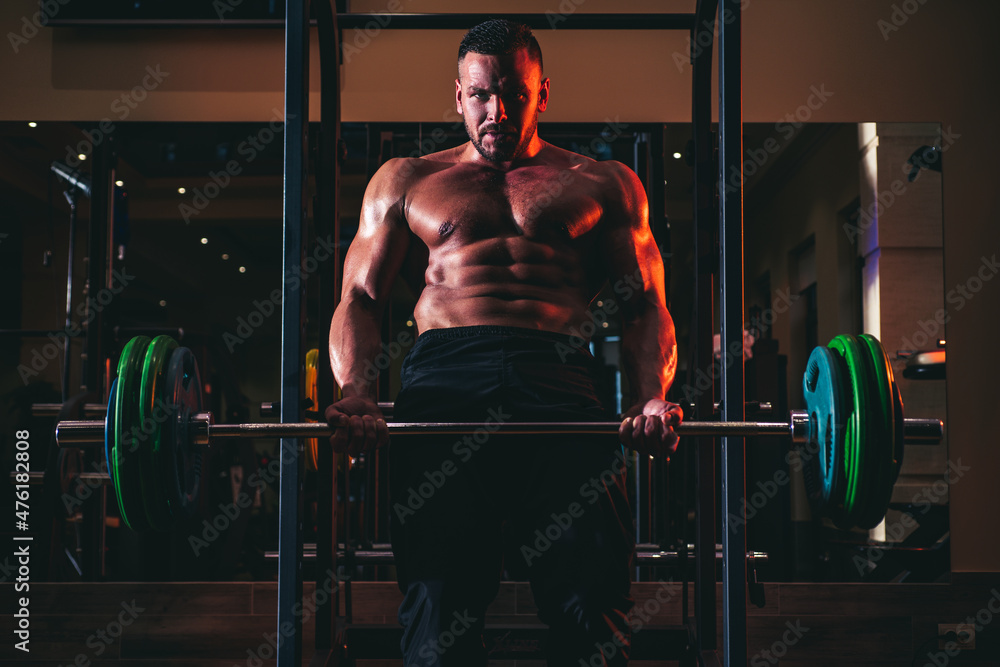 Muscular man doing crossfit. Muscular man doing biceps lifting barbell. Young man working out at crossfit gym. Athletic guy doing exercise. Muscular man doing crossfit. Muscular man doing biceps lifting barbell. Young man working out at crossfit gym. Athletic guy doing exercise.