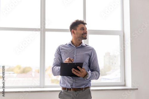 Portrait of a businessman holding a clipboard in office © F8  \ Suport Ukraine