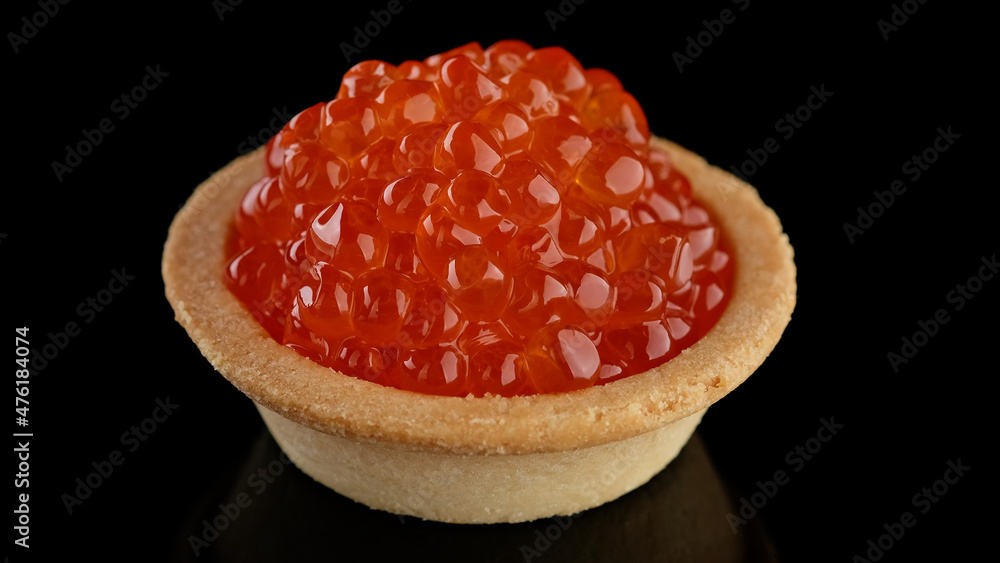 Snack with red caviar. Tartlet with red caviar close-up