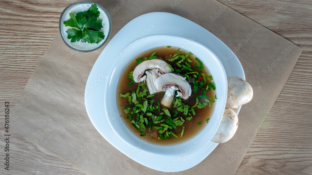 Close-up view of mushroom soup with green onions and champignons. Healthy food concepts. Close-up view of mushroom soup with green onions and champignons. Healthy food concepts.