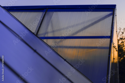 the roof of the greenhouse made of cellular polycarbonate at sunset