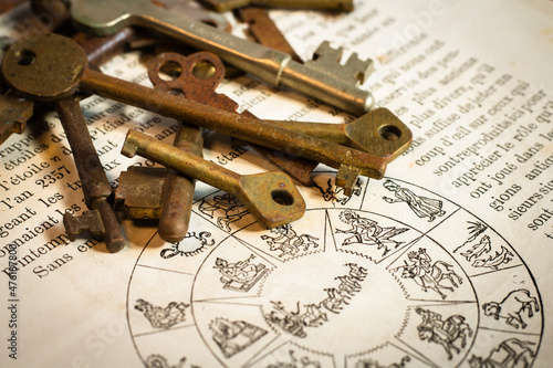 stacked old keys on the page of a French constellation book, フランス語の本 洋書 アンティークキー