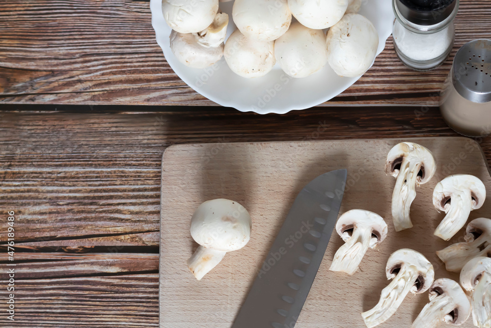 Fresh porcini mushrooms on a cutting board. On a tree background Fresh porcini mushrooms on a cutting board. On a tree background