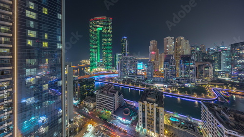 Dubai Marina skyscrapers and JBR district panorama with luxury buildings and resorts aerial night timelapse