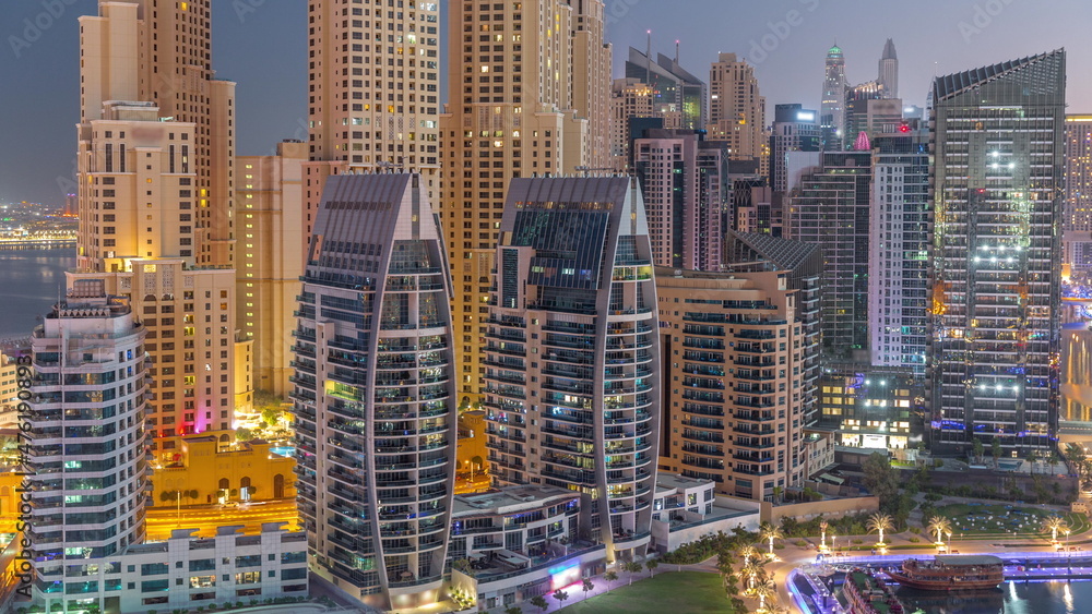 Fototapeta Dubai Marina skyscrapers and JBR district with luxury buildings and resorts aerial night to day timelapse