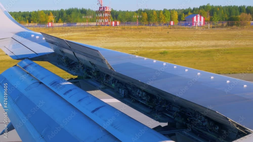 Airplane wing with open hydraulics in aileron position, landing