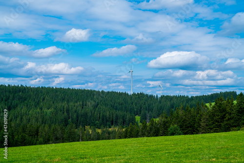 Germany, Black forest nature panorama with green conifer tree landscape and wind turbines to generate green renewable energy
