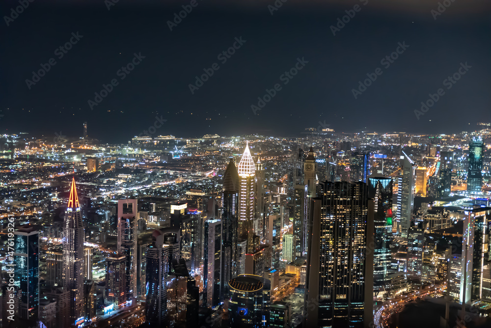Dubai, United Arab Emirates – December 14, 2021, the people visiting the the 24th and 25th floor of Burj Khalifa at night and shopping souvenirs at the shop