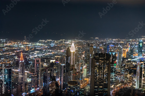 Dubai, United Arab Emirates – December 14, 2021, the people visiting the the 24th and 25th floor of Burj Khalifa at night and shopping souvenirs at the shop