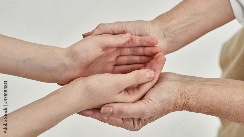 Fototapeta premium Granddaughter hands in hands of her grandmother