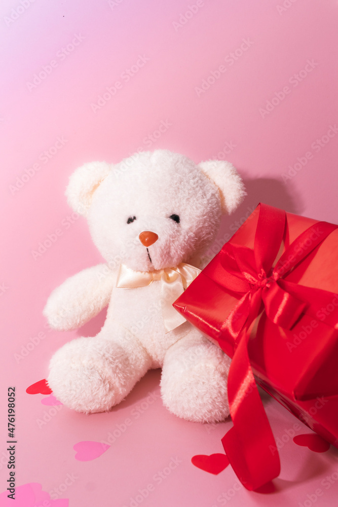 Cute white bear toy with red box on light pink background, space for text. Valentine's day celebration Cute white bear toy with red box on light pink background, space for text. Valentine's day celebration