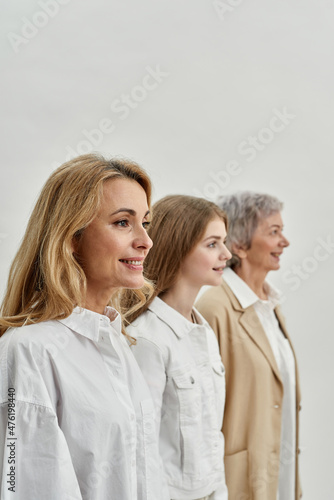 Row of smiling family of three female generations