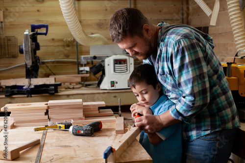 фотографія Father carpenter and son boy work in the workshop