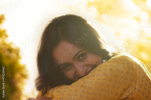 Close-up portrait of shy woman looking at camera