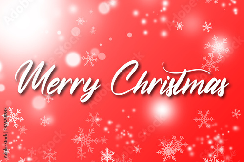 Merry Christmas text on red background. White Christmas text on red backdrop. White snow flakes and light bokeh.