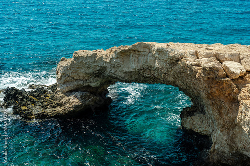 Azure sea around beautiful rocky arch