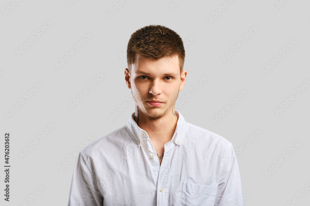 Handsome man in white shirt over grey background Handsome man in white shirt over grey background