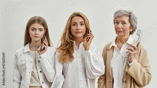 Family of three females with different phones