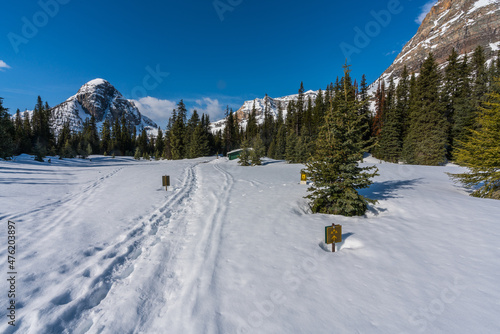 Egypt lake shelter covered in snow with Pharaoh peak towering behind, Banff, Canada