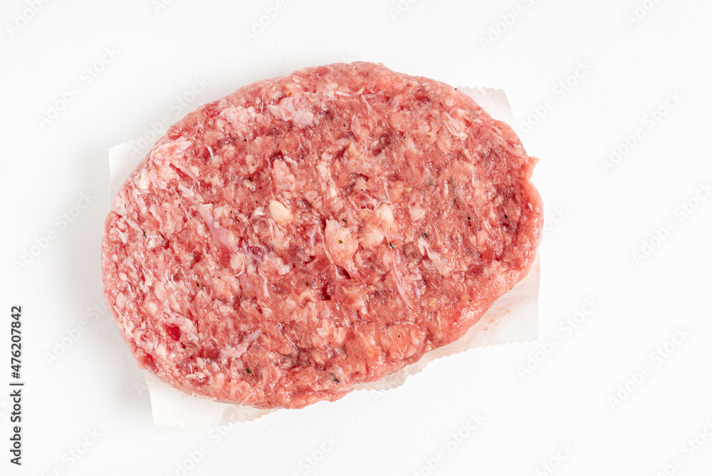 Raw minced homemade cutlets, on the white background Raw minced homemade cutlets, on the white background