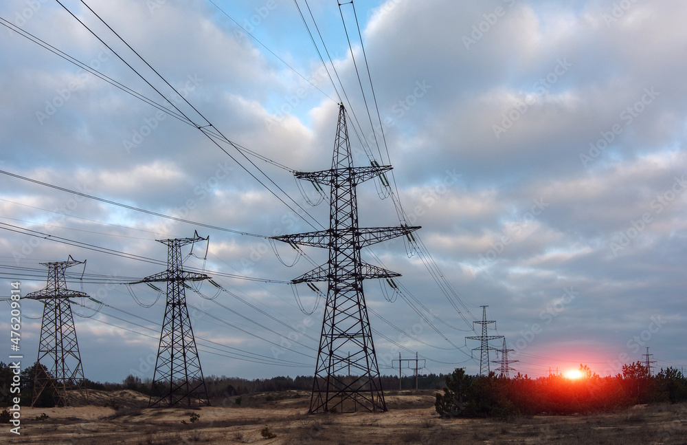  high-voltage  power lines at sunset.