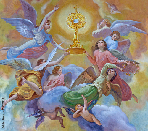FORLÍ, ITALY - NOVEMBER 11, 2021: The fresco of angels with eucharist in monstrance in the Cattedrala di Santa Croce by Giovanni Secchi (1876 - 1950). photo