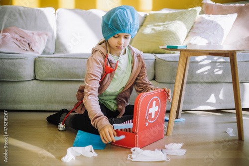 Focused female veterinarian with first aid kit in living room photo